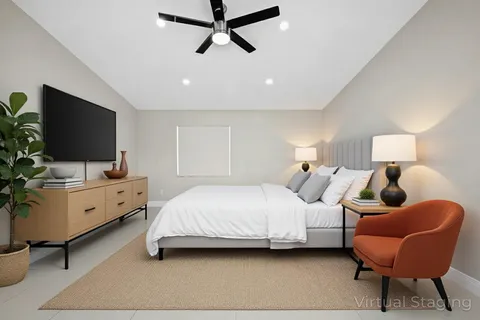 an empty room with a ceiling fan and window