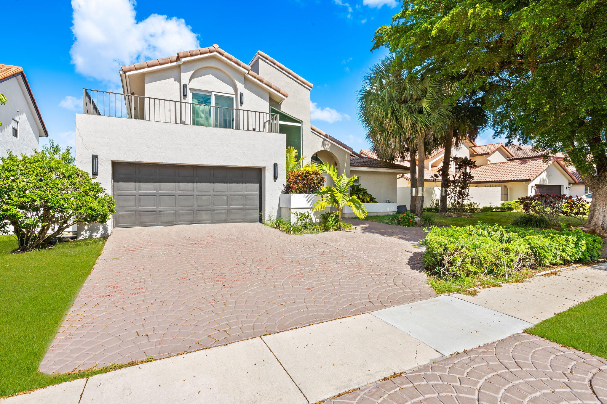 23162 L'Ermitage Circle Boca Raton, FL 33433 - Photo 3 of 48 a front view of a house with a yard and garage