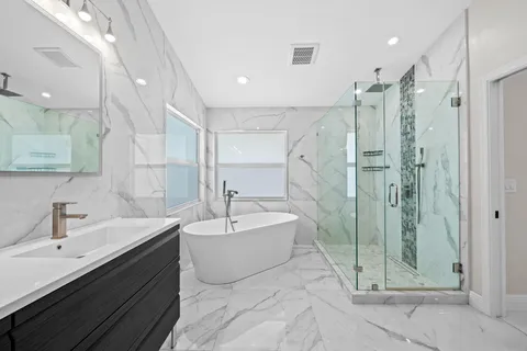 a bathroom with a double vanity sink mirror and shower