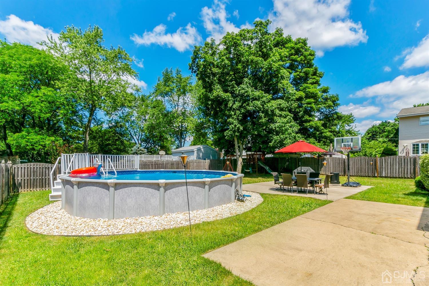 44 Gramercy Road Old Bridge, NJ 08857 - Photo 25 of 27 a view of a swimming pool with a patio and a yard