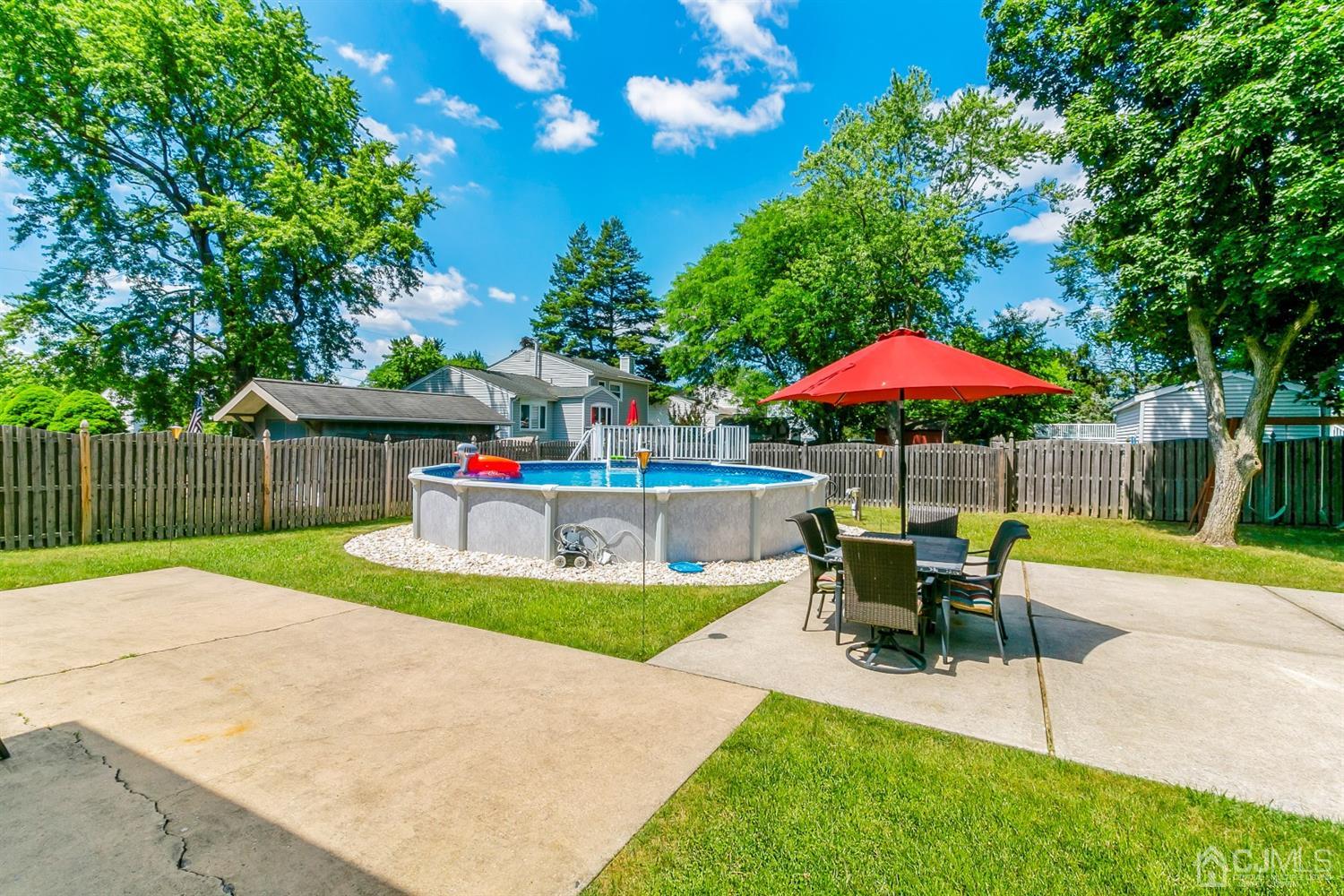 44 Gramercy Road Old Bridge, NJ 08857 - Photo 26 of 27 a view of pool with table and chairs under an umbrella