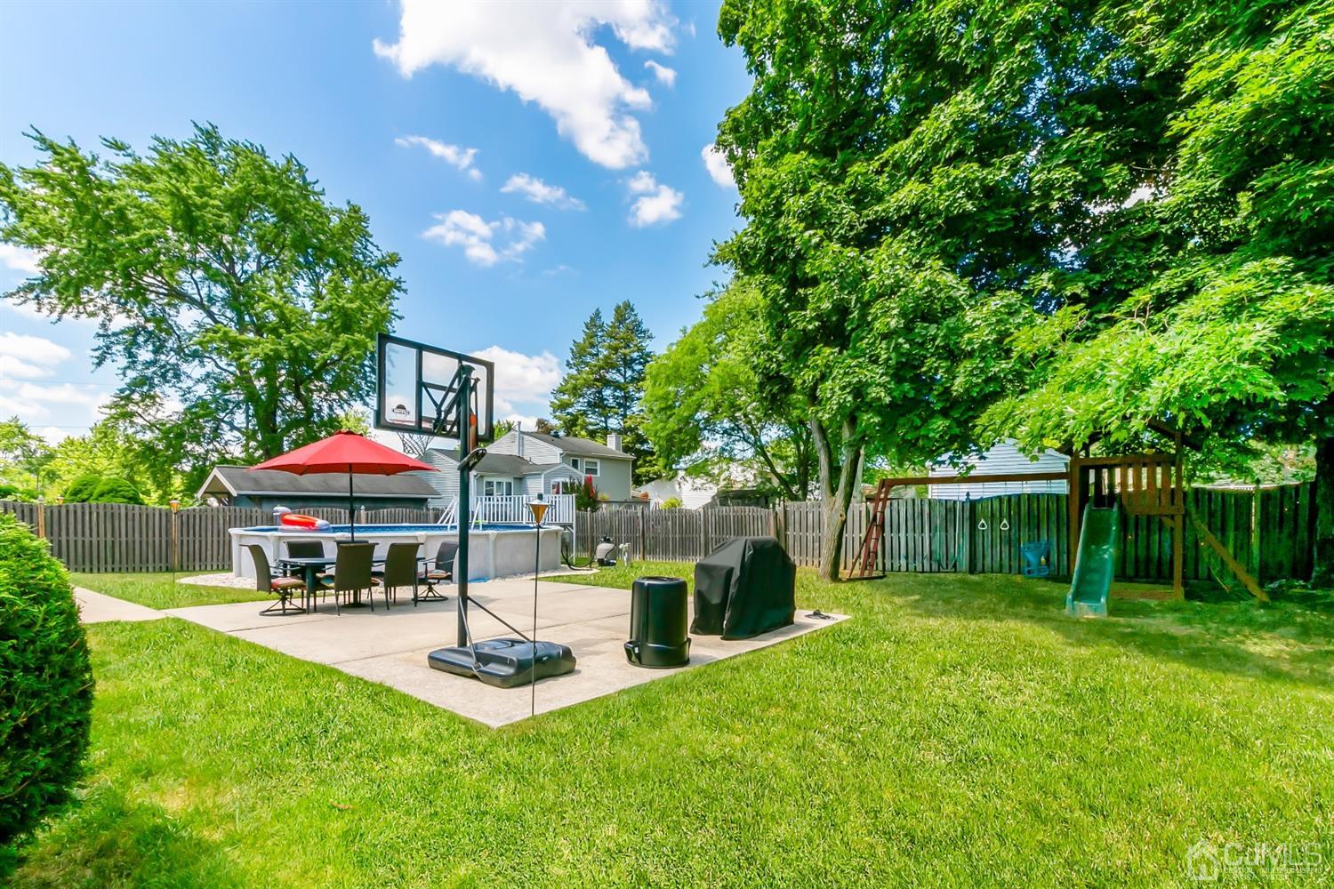 44 Gramercy Road Old Bridge, NJ 08857 - Photo 27 of 27 a view of a patio with a table and chairs under an umbrella