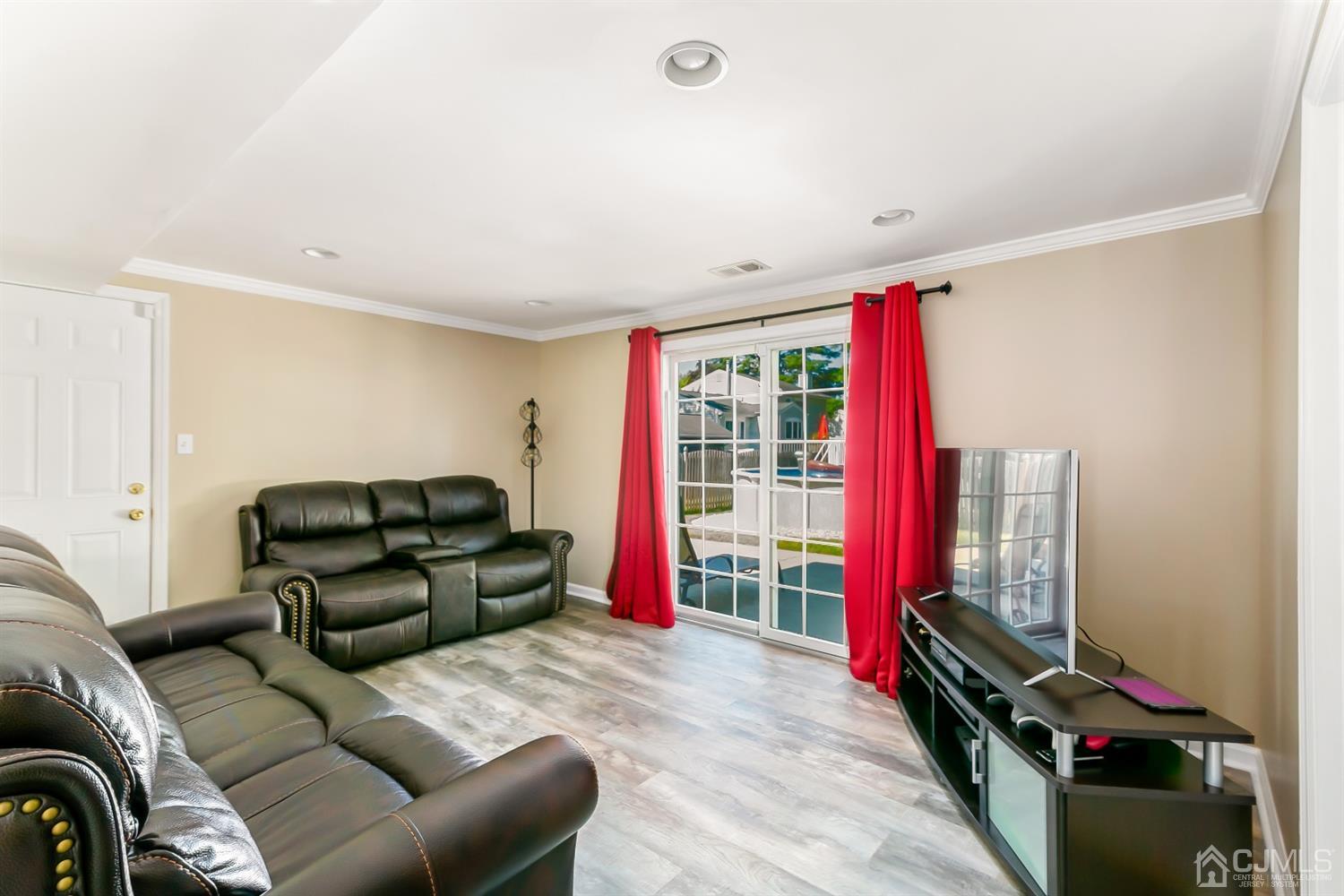 44 Gramercy Road Old Bridge, NJ 08857 - Photo 5 of 27 a living room with furniture a flat screen tv and a large window