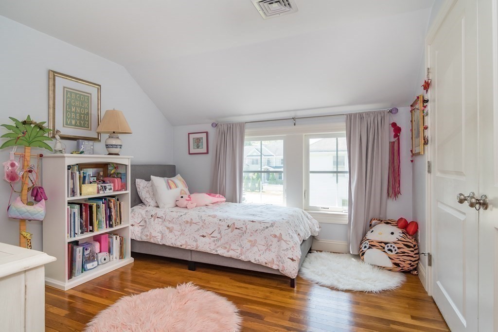 3 Claflin Road Wellesley, MA 02482 - Photo 13 of 20 a bedroom with a bed and a book shelf