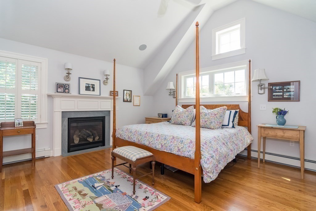3 Claflin Road Wellesley, MA 02482 - Photo 14 of 20 a bedroom with a bed and a fireplace