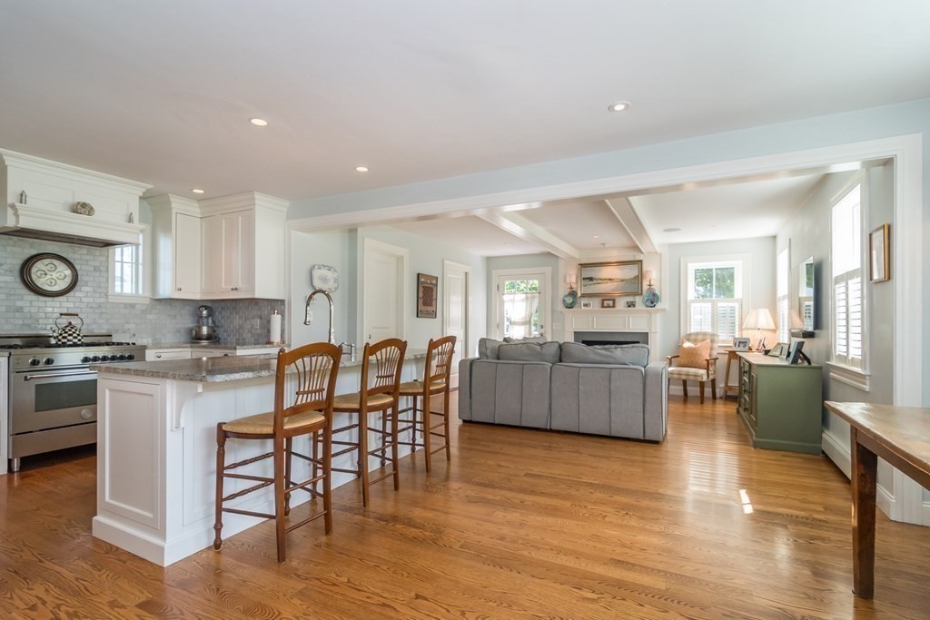 3 Claflin Road Wellesley, MA 02482 - Photo 6 of 20 a kitchen with stainless steel appliances granite countertop wooden cabinets a stove a sink a dining table and chairs