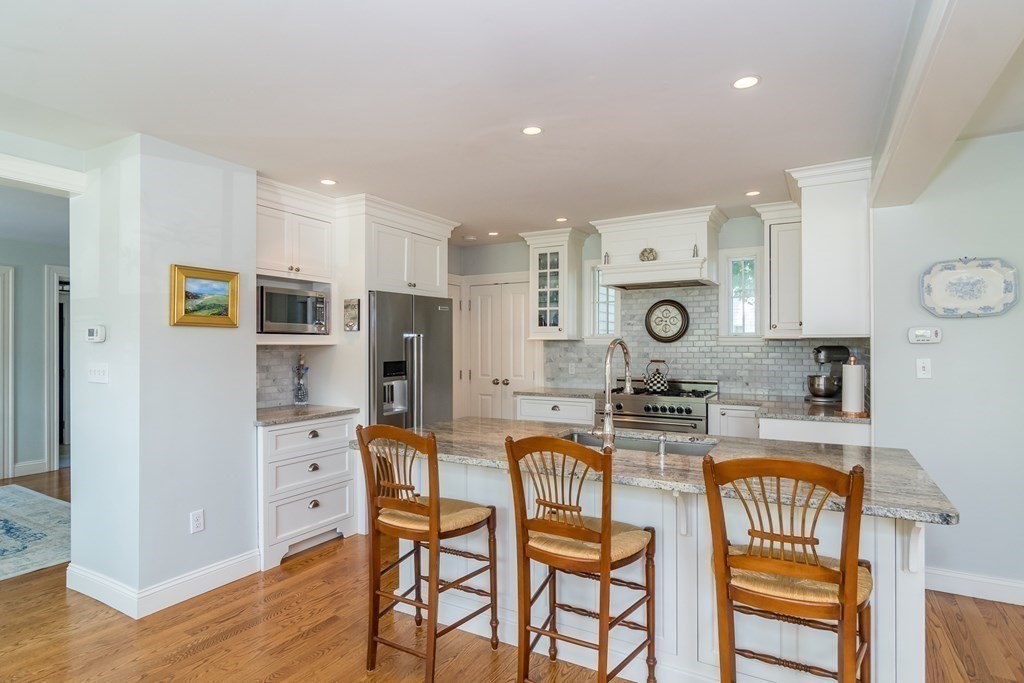 3 Claflin Road Wellesley, MA 02482 - Photo 7 of 20 a kitchen with stainless steel appliances kitchen island granite countertop a refrigerator and microwave
