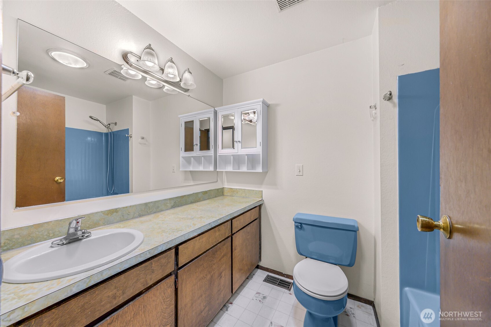 5925 Longdin Road Ferndale, WA 98248 - Photo 12 of 28 a bathroom with a granite countertop sink a toilet a mirror and shower