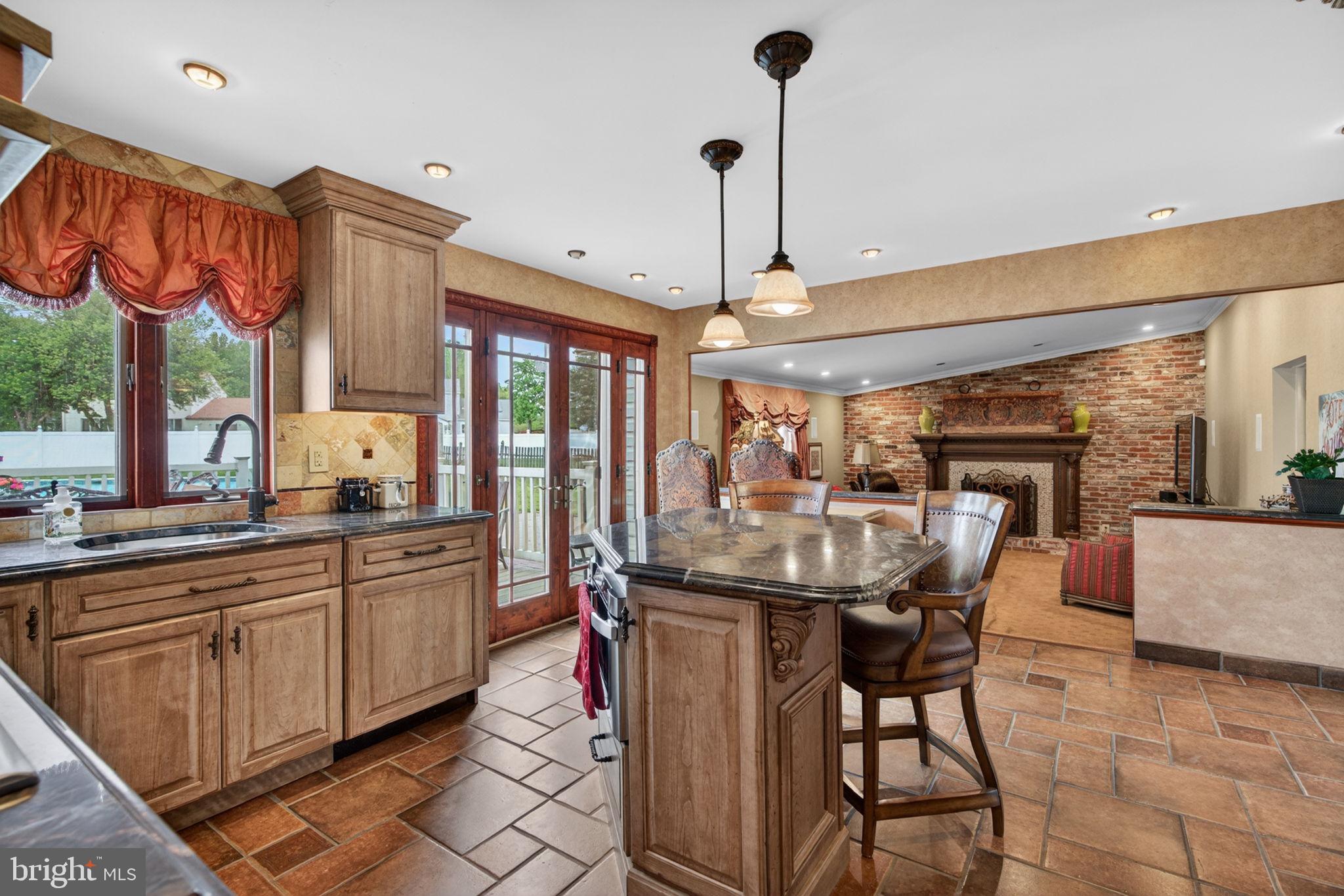 24 Millbridge Road Clementon, NJ 08021 - Photo 12 of 46 a view of a kitchen with kitchen island granite countertop a table and chairs in it