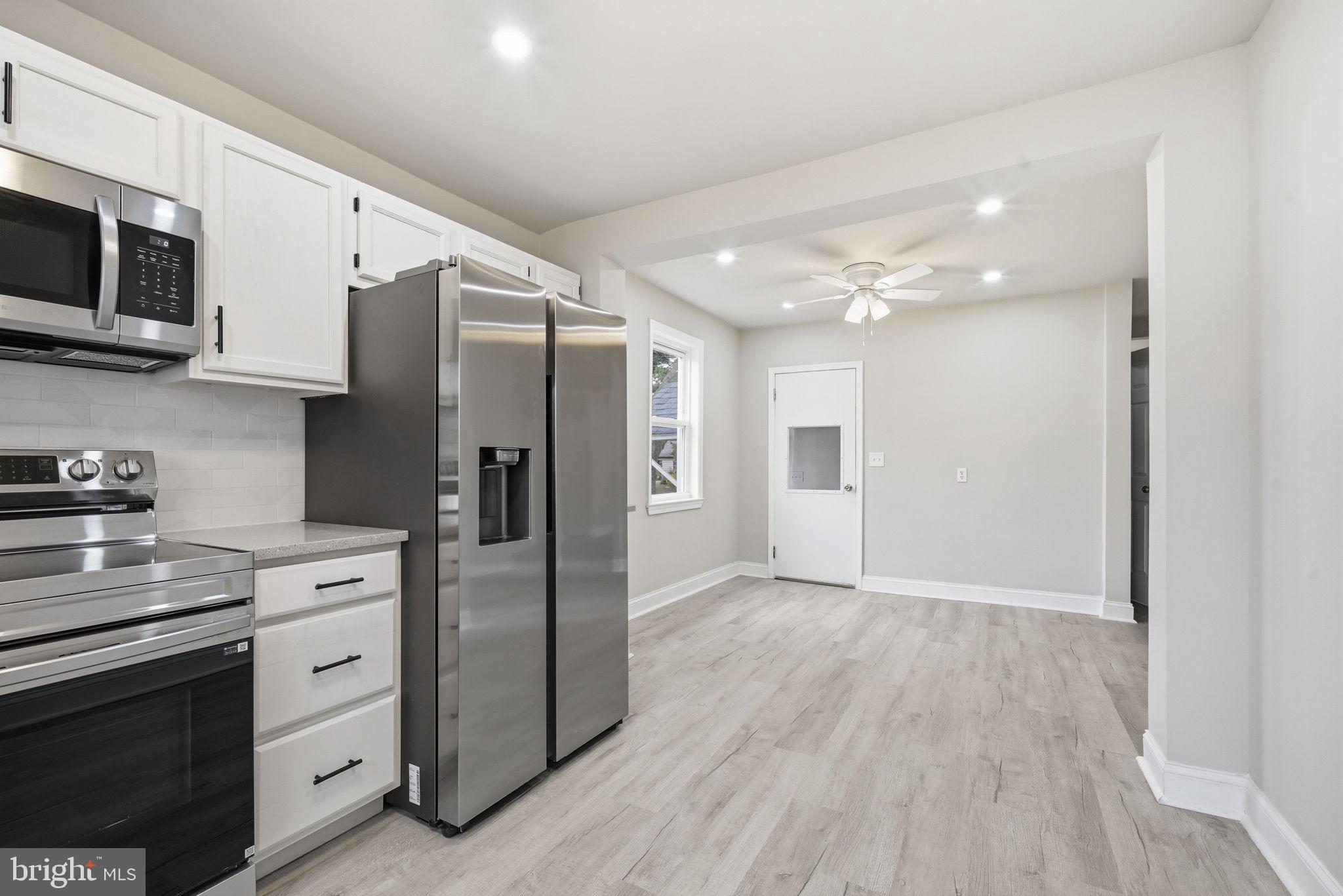21305 Haven Road Rock Hall, MD 21661 - Photo 12 of 52 a kitchen with stainless steel appliances a refrigerator sink and microwave