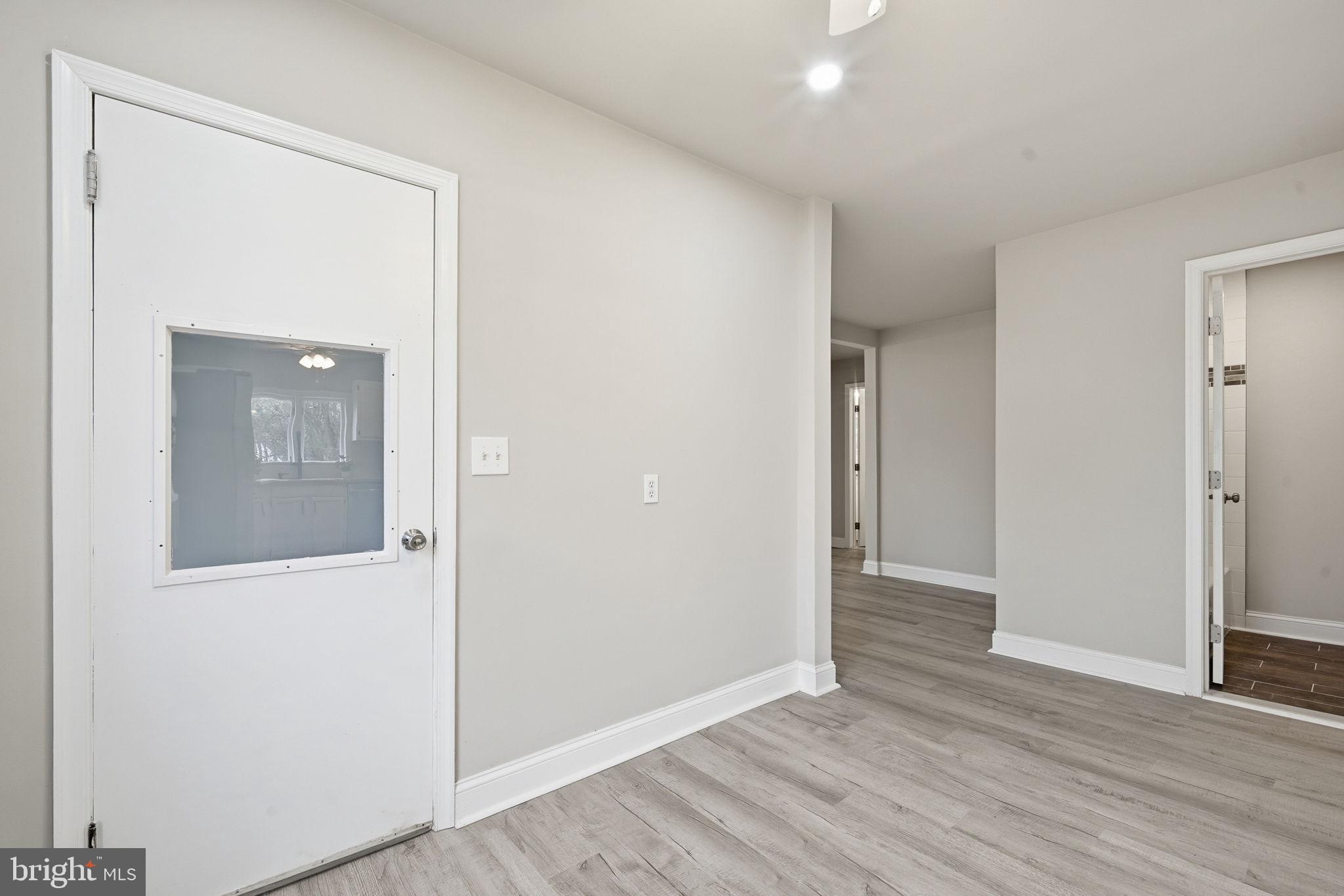 21305 Haven Road Rock Hall, MD 21661 - Photo 14 of 52 an empty room with wooden floor and windows