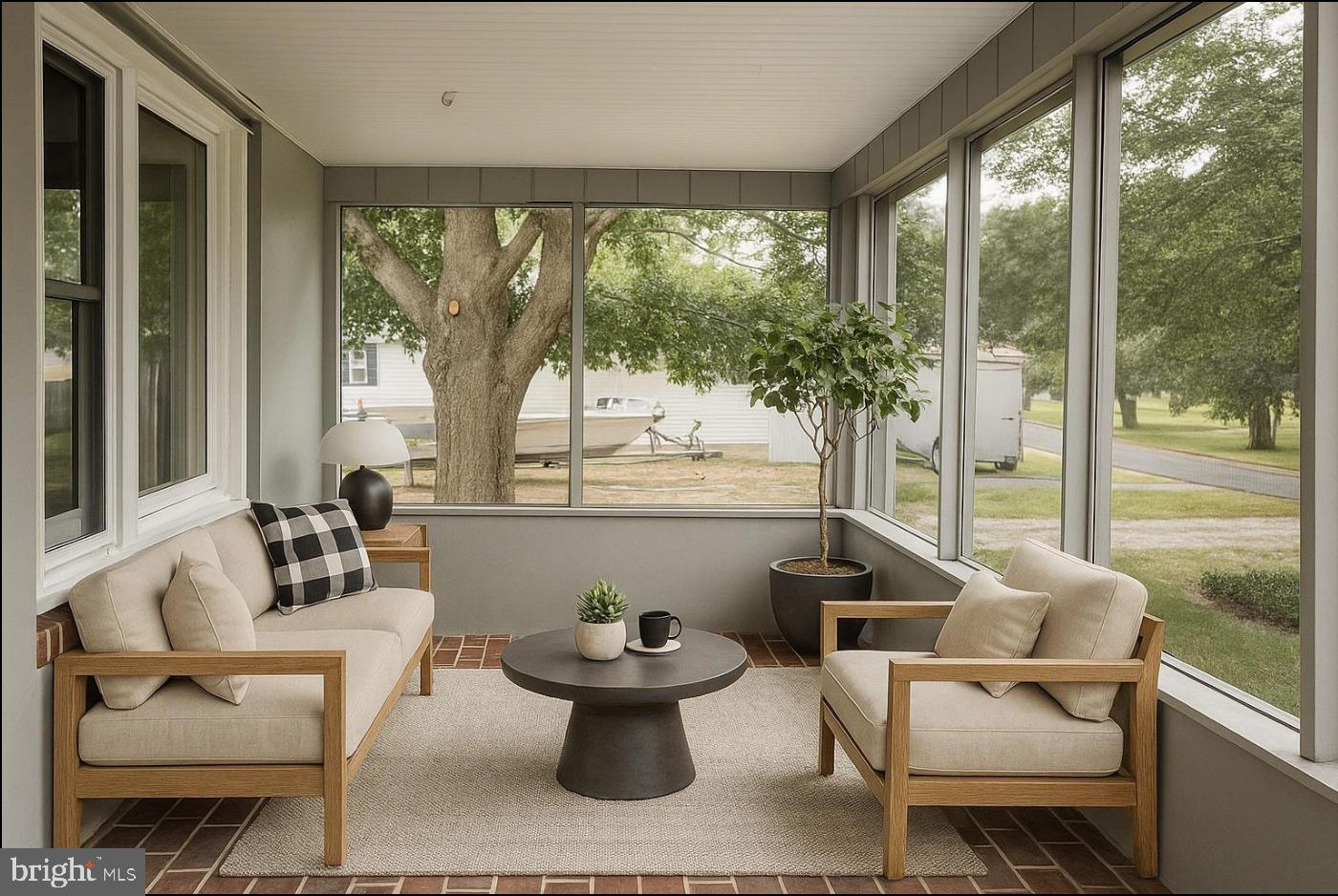 21305 Haven Road Rock Hall, MD 21661 - Photo 16 of 52 a living room with patio furniture and a potted plant