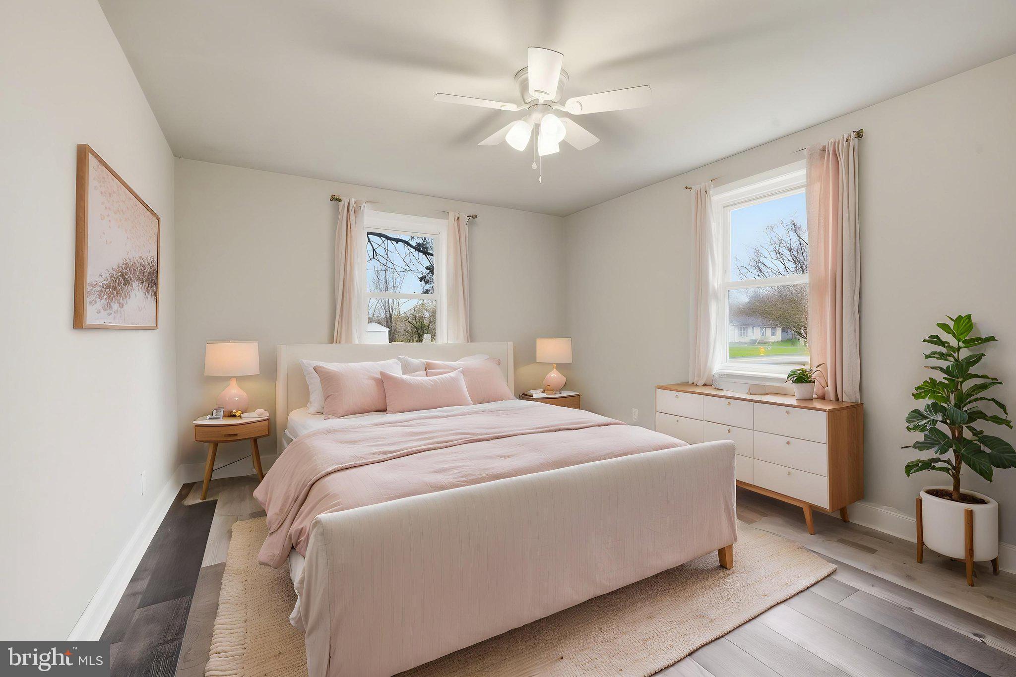 21305 Haven Road Rock Hall, MD 21661 - Photo 18 of 52 a bedroom with a large bed and a chandelier
