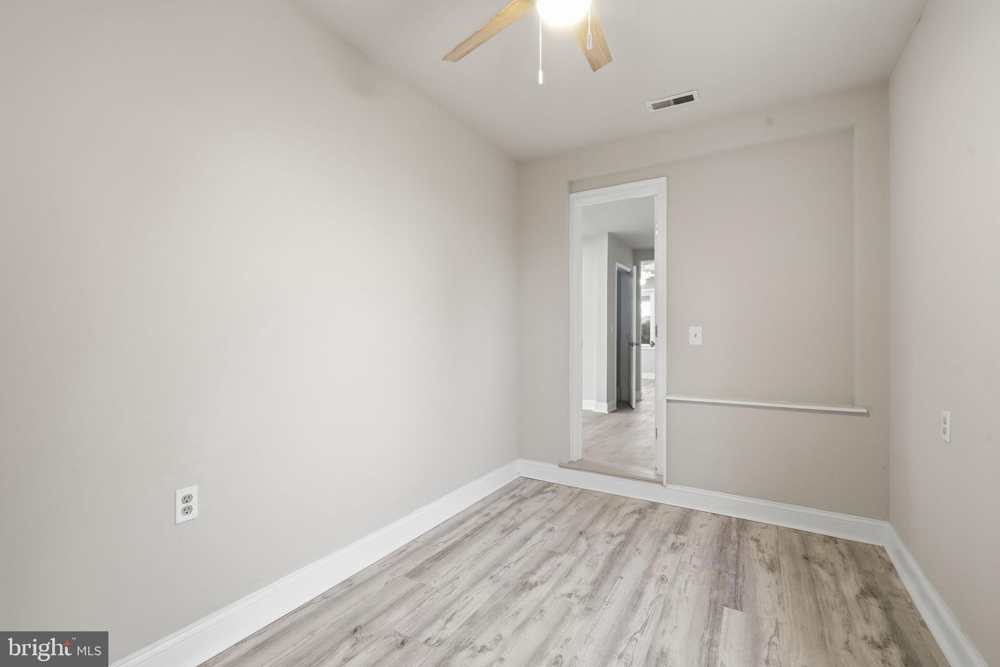 21305 Haven Road Rock Hall, MD 21661 - Photo 24 of 52 an empty room with wooden floor and windows