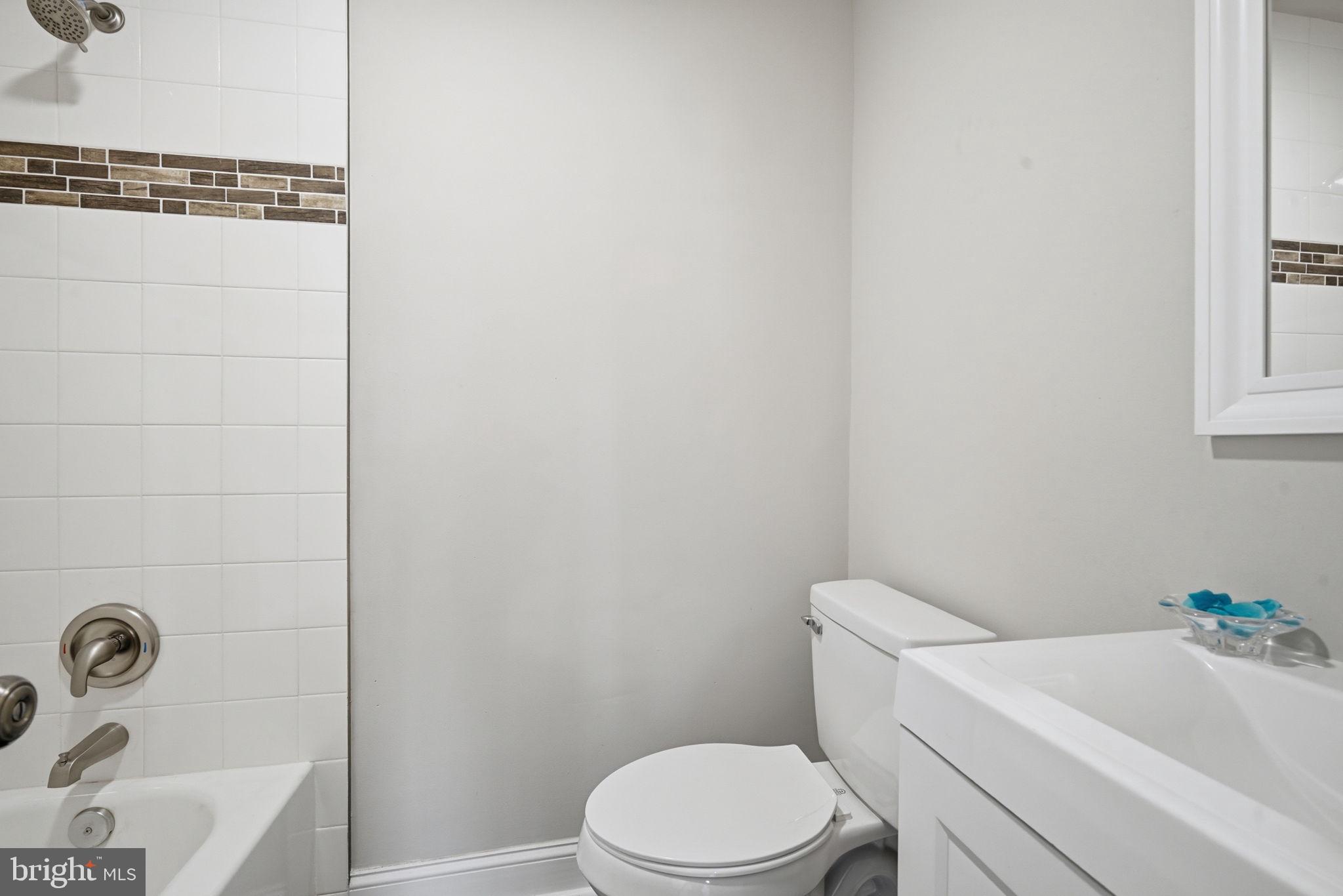 21305 Haven Road Rock Hall, MD 21661 - Photo 27 of 52 a white toilet sitting next to a bathroom sink