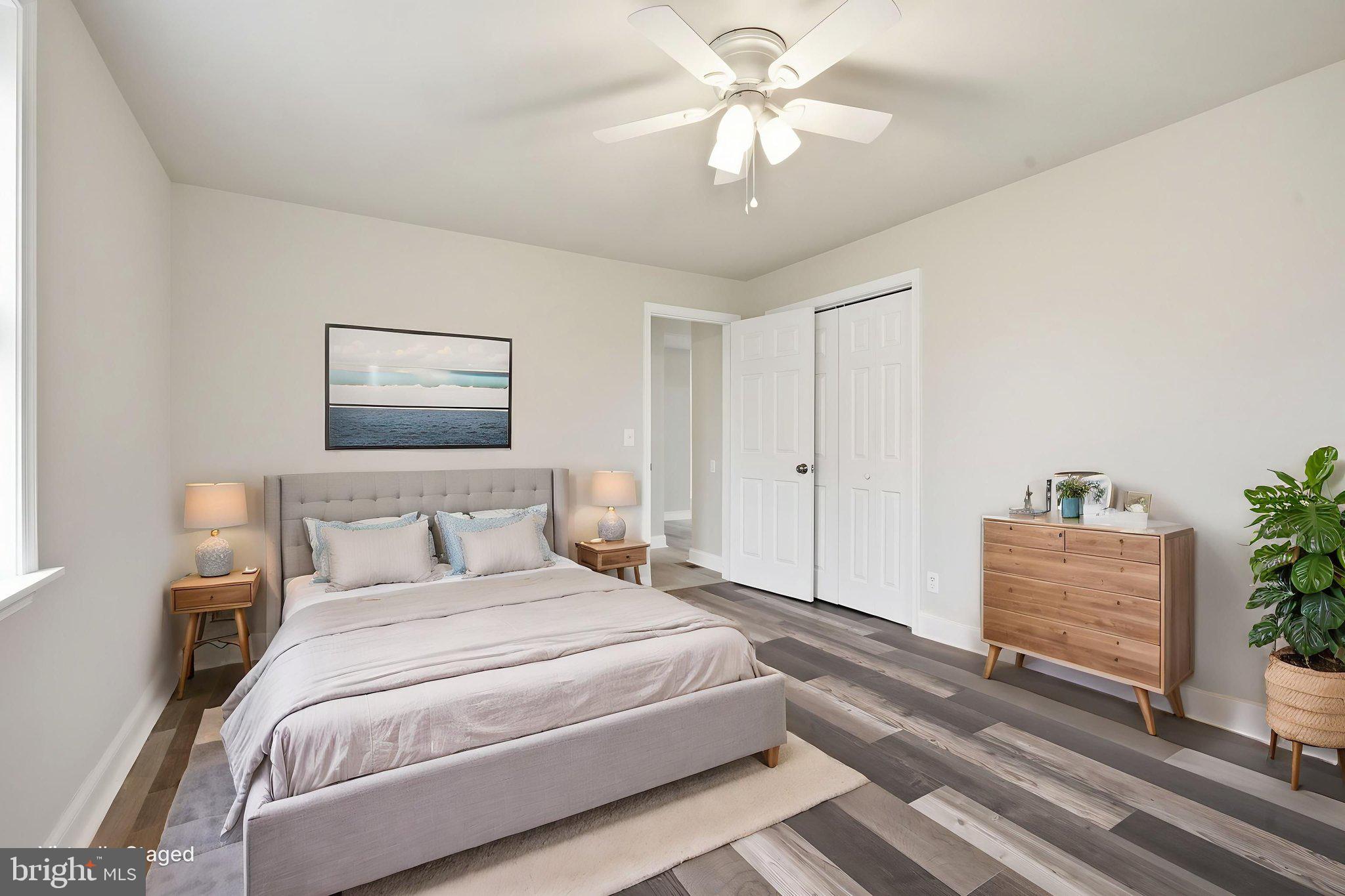 21305 Haven Road Rock Hall, MD 21661 - Photo 28 of 52 a bedroom with a bed and a chandelier
