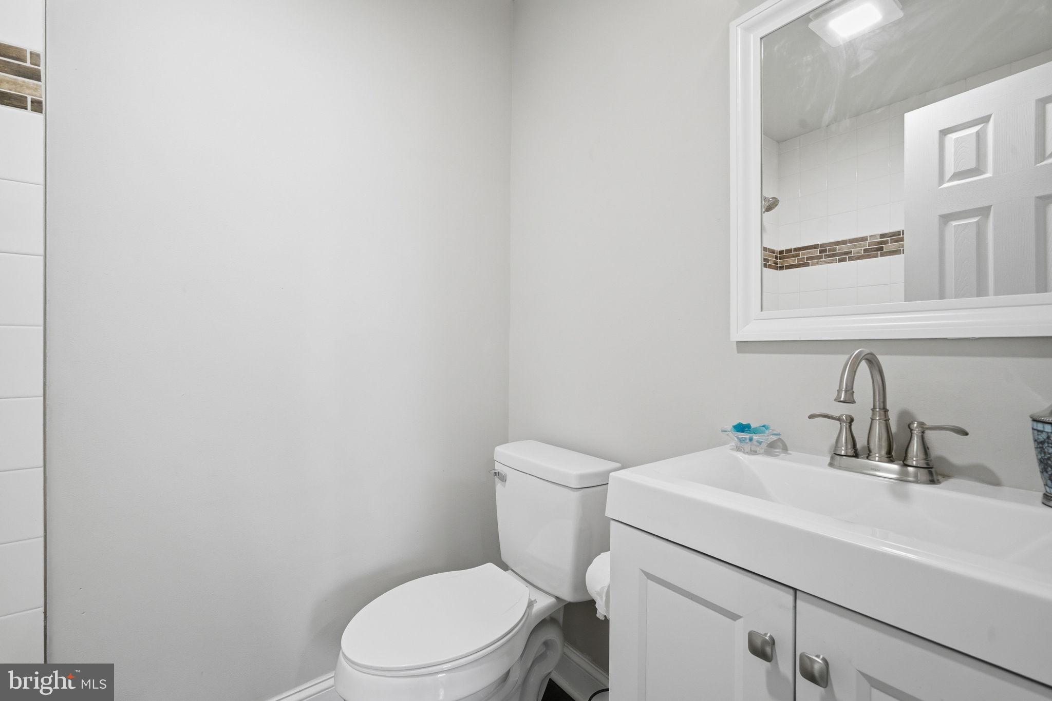 21305 Haven Road Rock Hall, MD 21661 - Photo 31 of 52 a bathroom with a sink a toilet and mirror