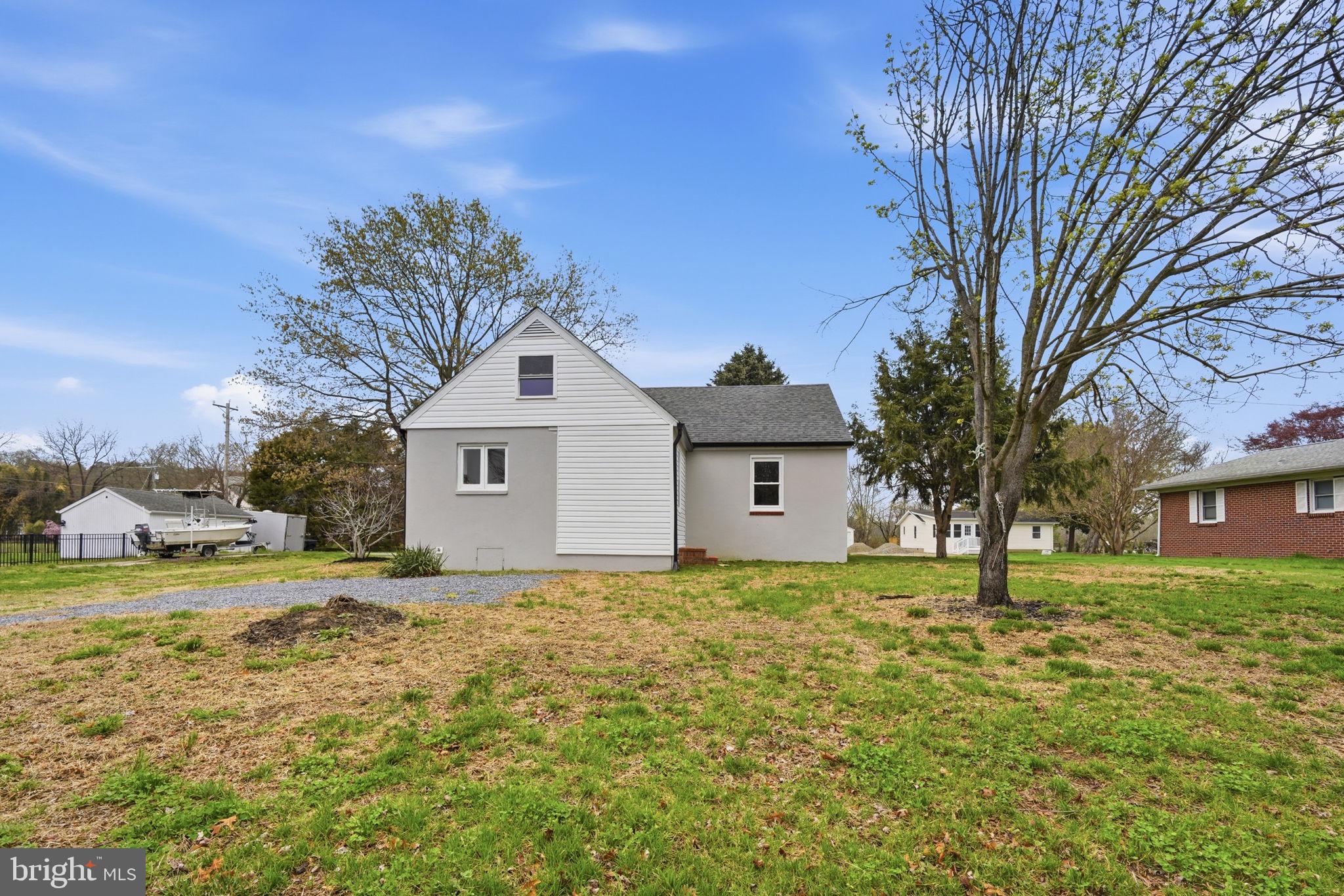 21305 Haven Road Rock Hall, MD 21661 - Photo 5 of 52 a front view of a house with a yard