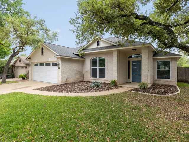 a front view of a house with a yard and garage