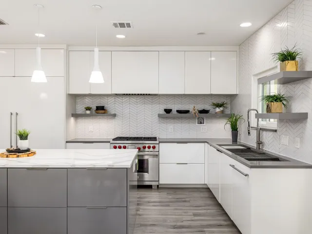 a kitchen with stainless steel appliances granite countertop a sink stove and cabinets