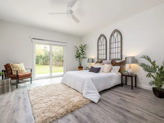 a spacious bedroom with a bed and a large window