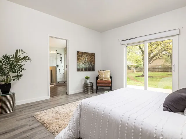 a bedroom with a bed and a large window