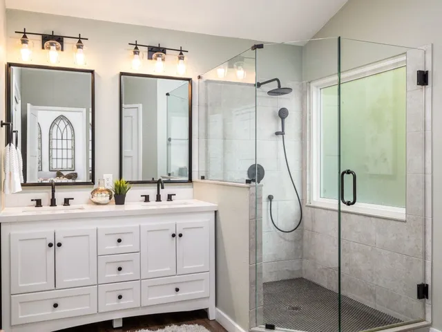 a bathroom with a double vanity sink mirror and double