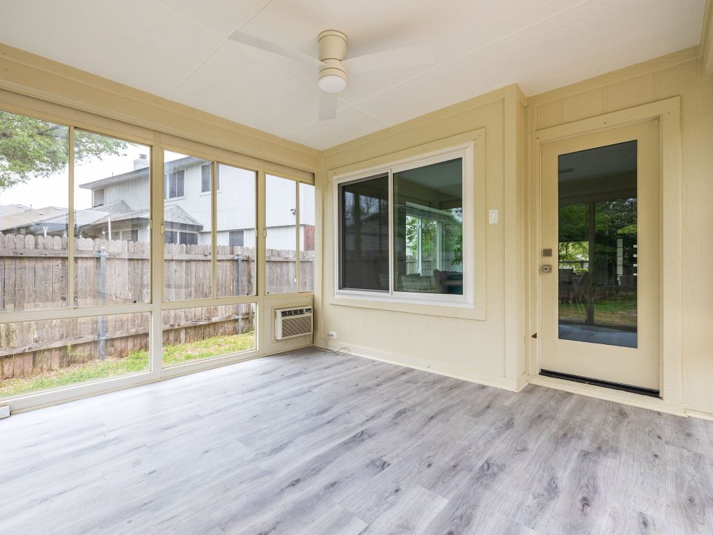 8004 Osborne Drive Austin, TX 78729 - Photo 17 of 24 a view of an empty room with wooden floor and a window