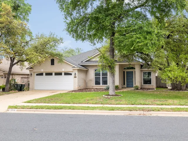 a house that has a tree in front of it