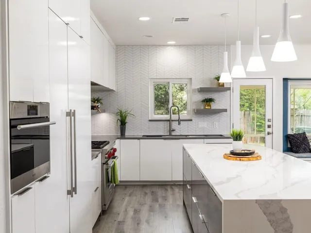 a kitchen with a sink a counter top space stainless steel appliances and a window