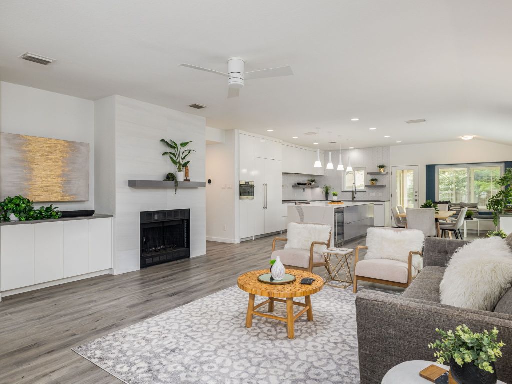 8004 Osborne Drive Austin, TX 78729 - Photo 6 of 24 a living room with furniture a fireplace and a flat screen tv
