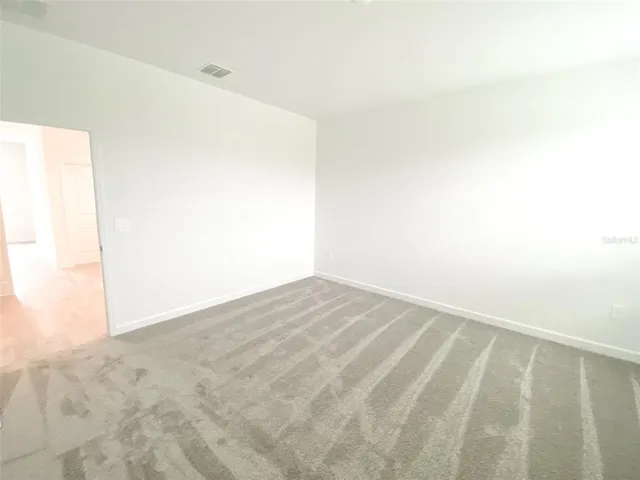 a bathroom with a double vanity sink a toilet and a mirror