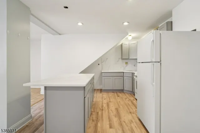 a white refrigerator freezer and a stove sitting inside of a kitchen