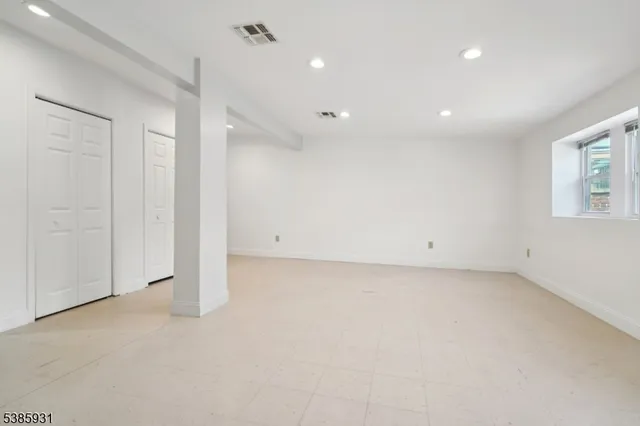 an empty room with a empty space and windows