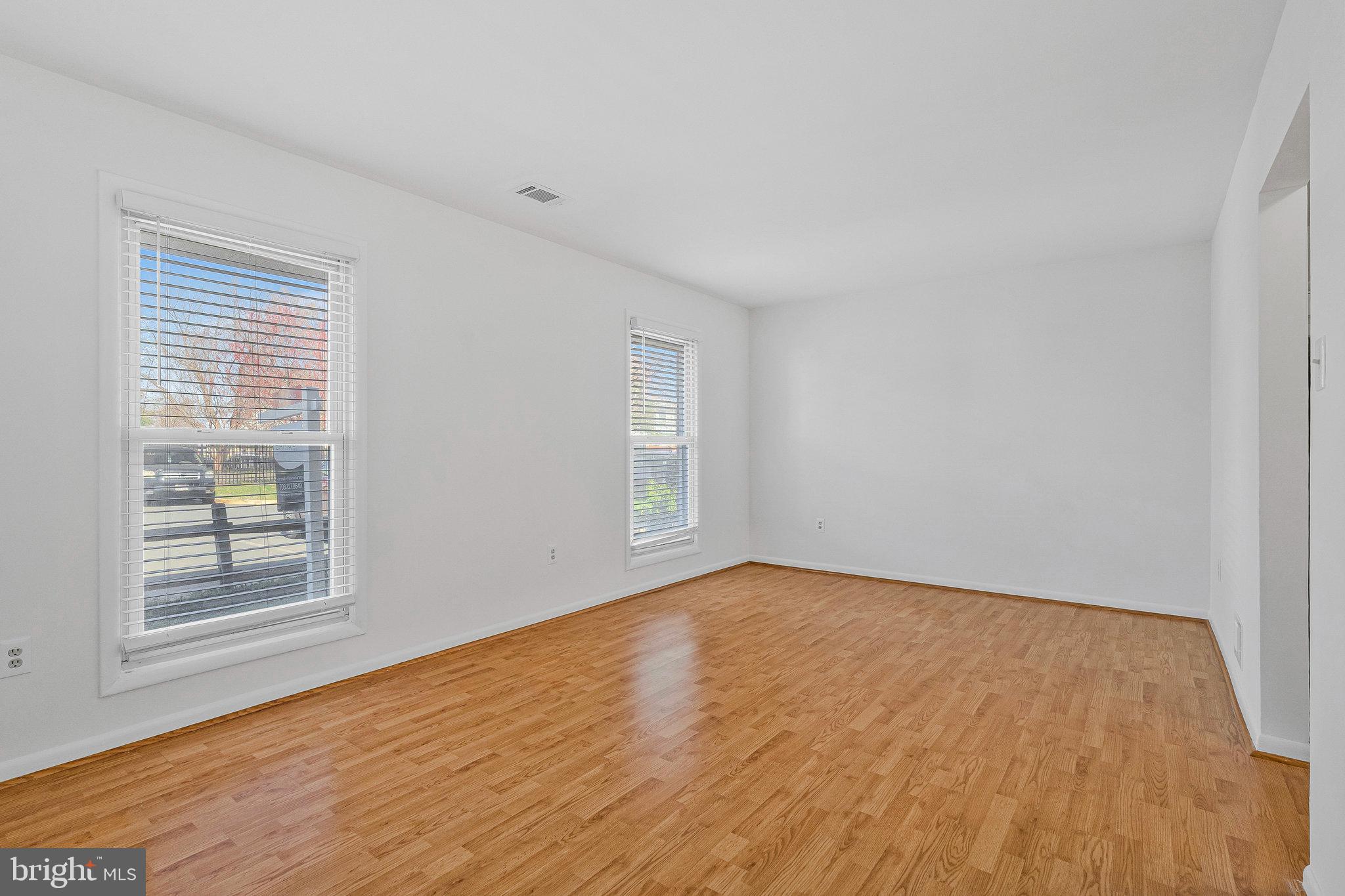 2131 Ferguson Place Herndon, VA 20170 - Photo 19 of 27 a view of an empty room with wooden floor and a window