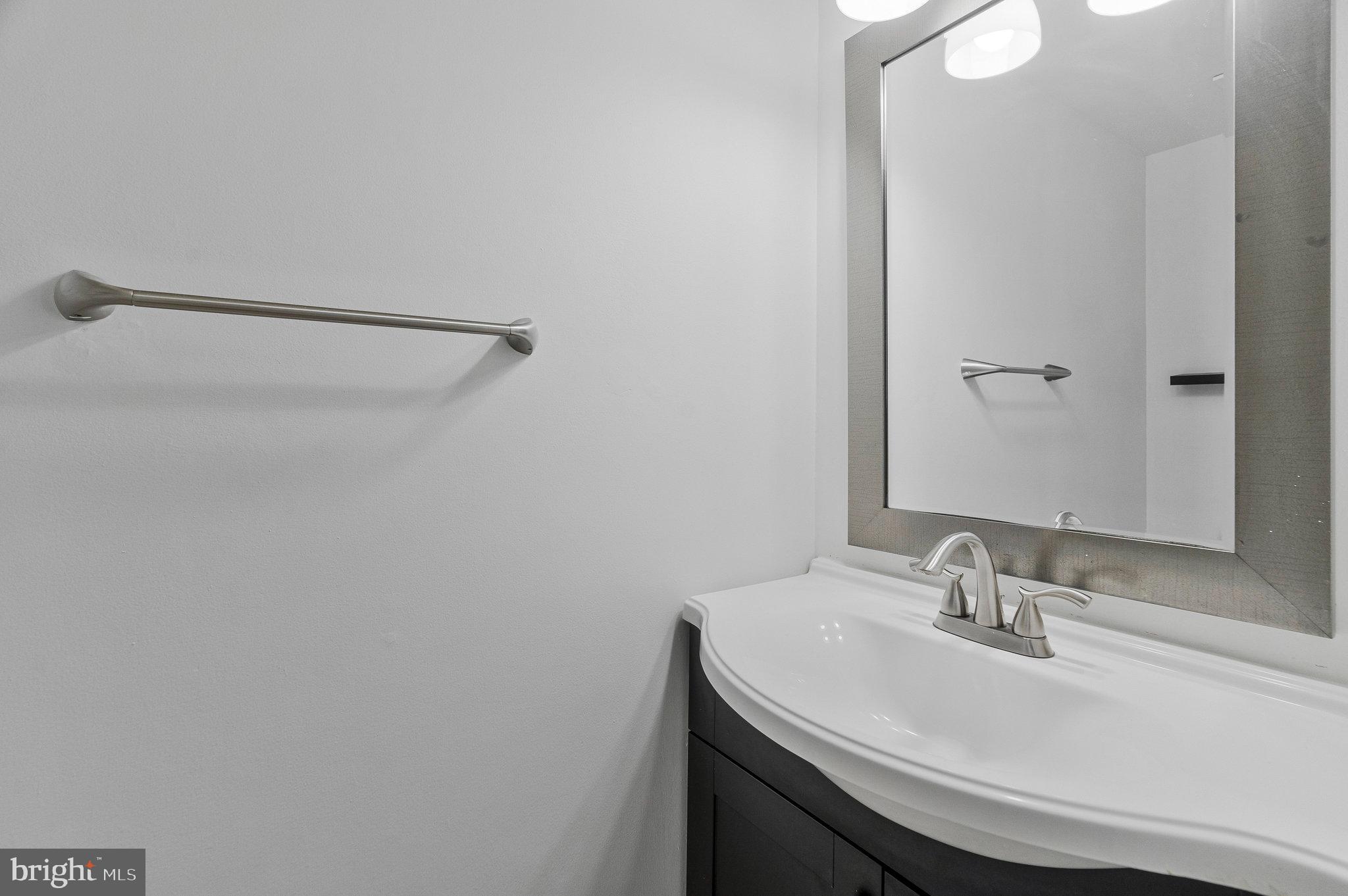 2131 Ferguson Place Herndon, VA 20170 - Photo 21 of 27 a bathroom with a sink and a mirror