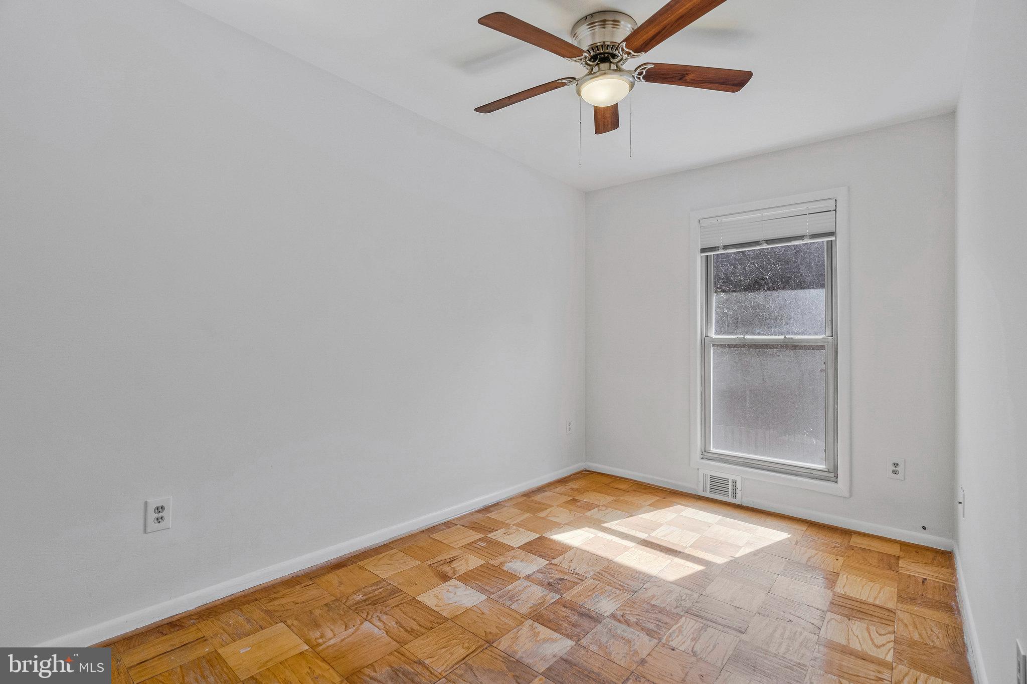 2131 Ferguson Place Herndon, VA 20170 - Photo 23 of 27 an empty room with a ceiling fan and window