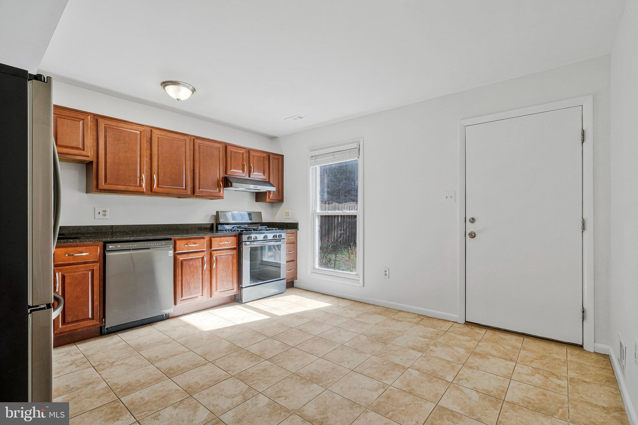 2131 Ferguson Place Herndon, VA 20170 - Photo 6 of 27 a kitchen with stainless steel appliances granite countertop a stove top oven a sink and dishwasher