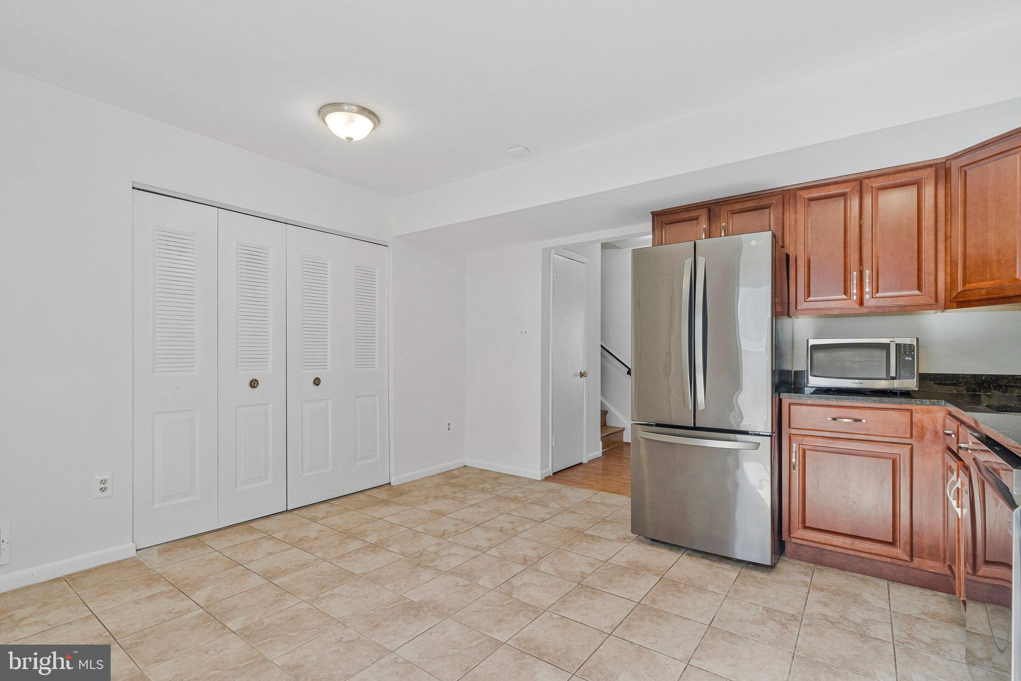 2131 Ferguson Place Herndon, VA 20170 - Photo 8 of 27 a kitchen with cabinets and stainless steel appliances