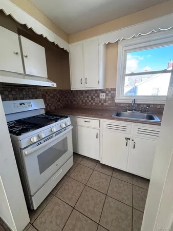 a kitchen with stainless steel appliances a sink and a refrigerator