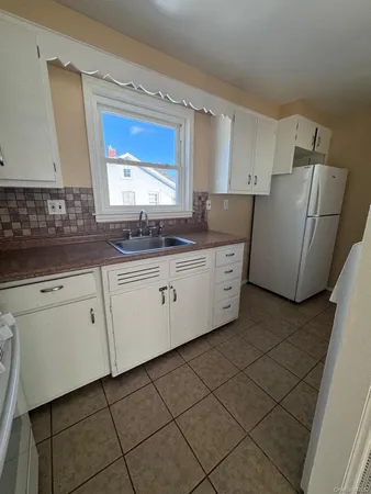 a kitchen with stainless steel appliances granite countertop a refrigerator and a stove