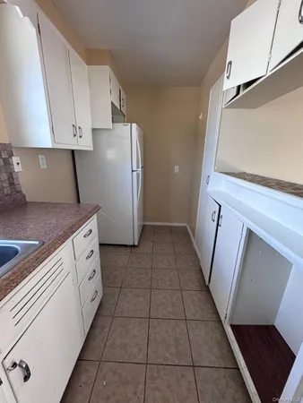 a kitchen with a sink a stove and cabinets