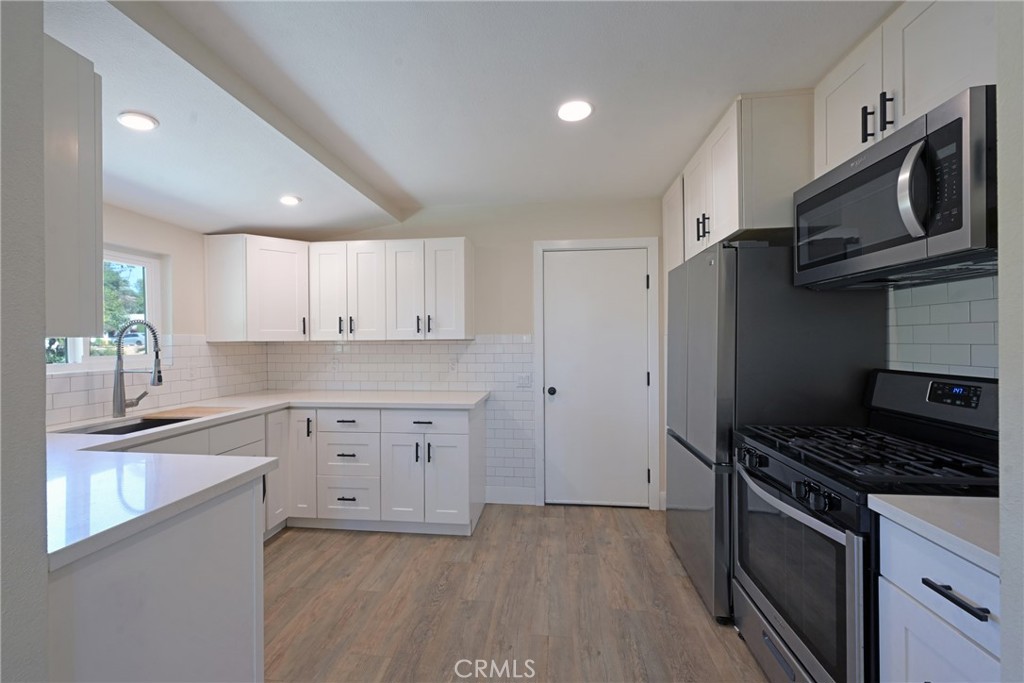 127 East College Street Fallbrook, CA 92028 - Photo 13 of 58 a kitchen with granite countertop a sink stainless steel appliances and cabinets