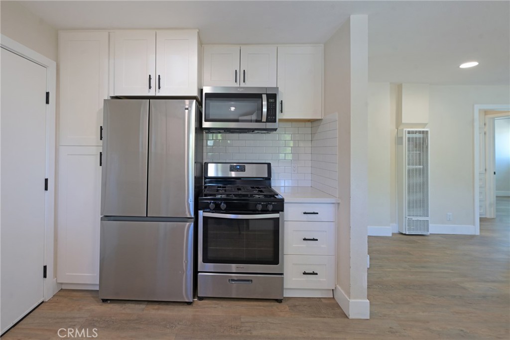 127 East College Street Fallbrook, CA 92028 - Photo 14 of 58 a kitchen with stainless steel appliances granite countertop a refrigerator a stove a microwave and cabinets