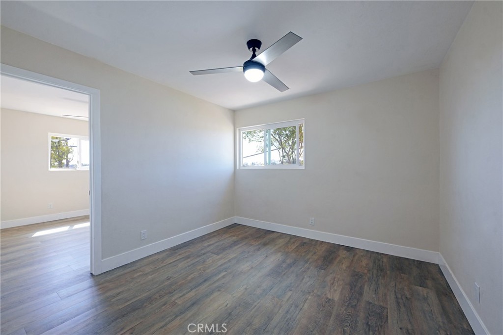 127 East College Street Fallbrook, CA 92028 - Photo 19 of 58 a view of an empty room with wooden floor and a window