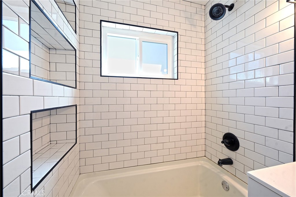 127 East College Street Fallbrook, CA 92028 - Photo 20 of 58 a bathroom with a bathtub and shower