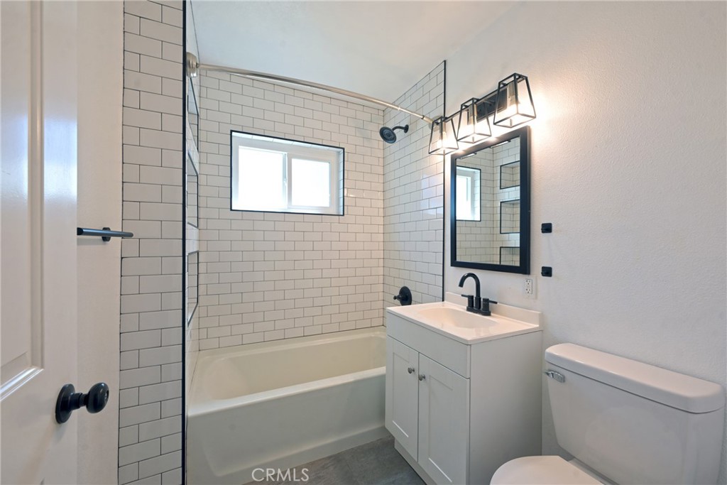 127 East College Street Fallbrook, CA 92028 - Photo 21 of 58 a bathroom with a sink a toilet and shower