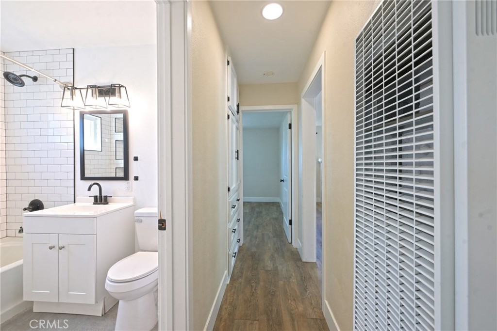 127 East College Street Fallbrook, CA 92028 - Photo 22 of 58 a bathroom with a toilet sink and mirror