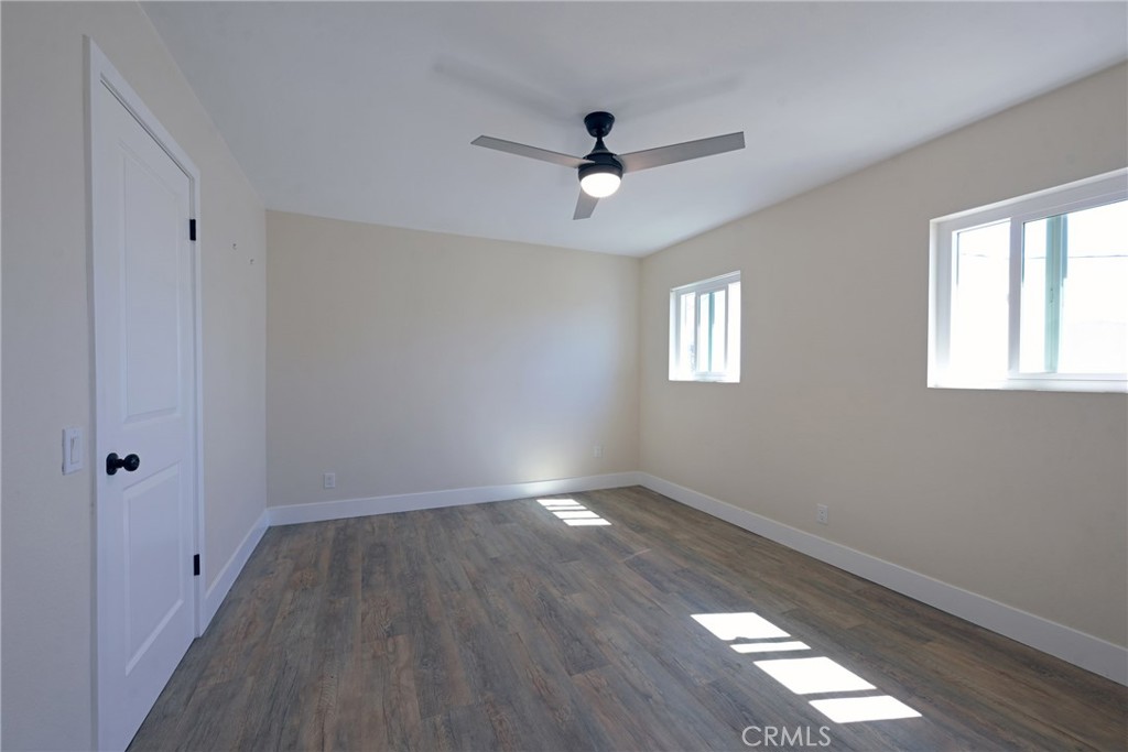 127 East College Street Fallbrook, CA 92028 - Photo 23 of 58 a view of an empty room with wooden floor and a window