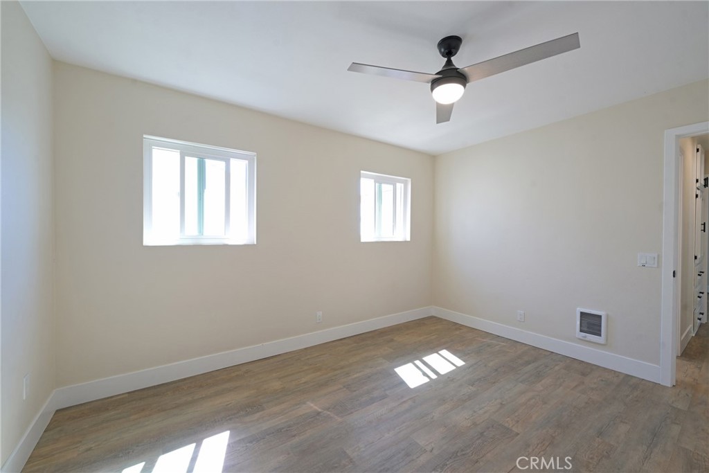127 East College Street Fallbrook, CA 92028 - Photo 24 of 58 a view of empty room with wooden floor and fan